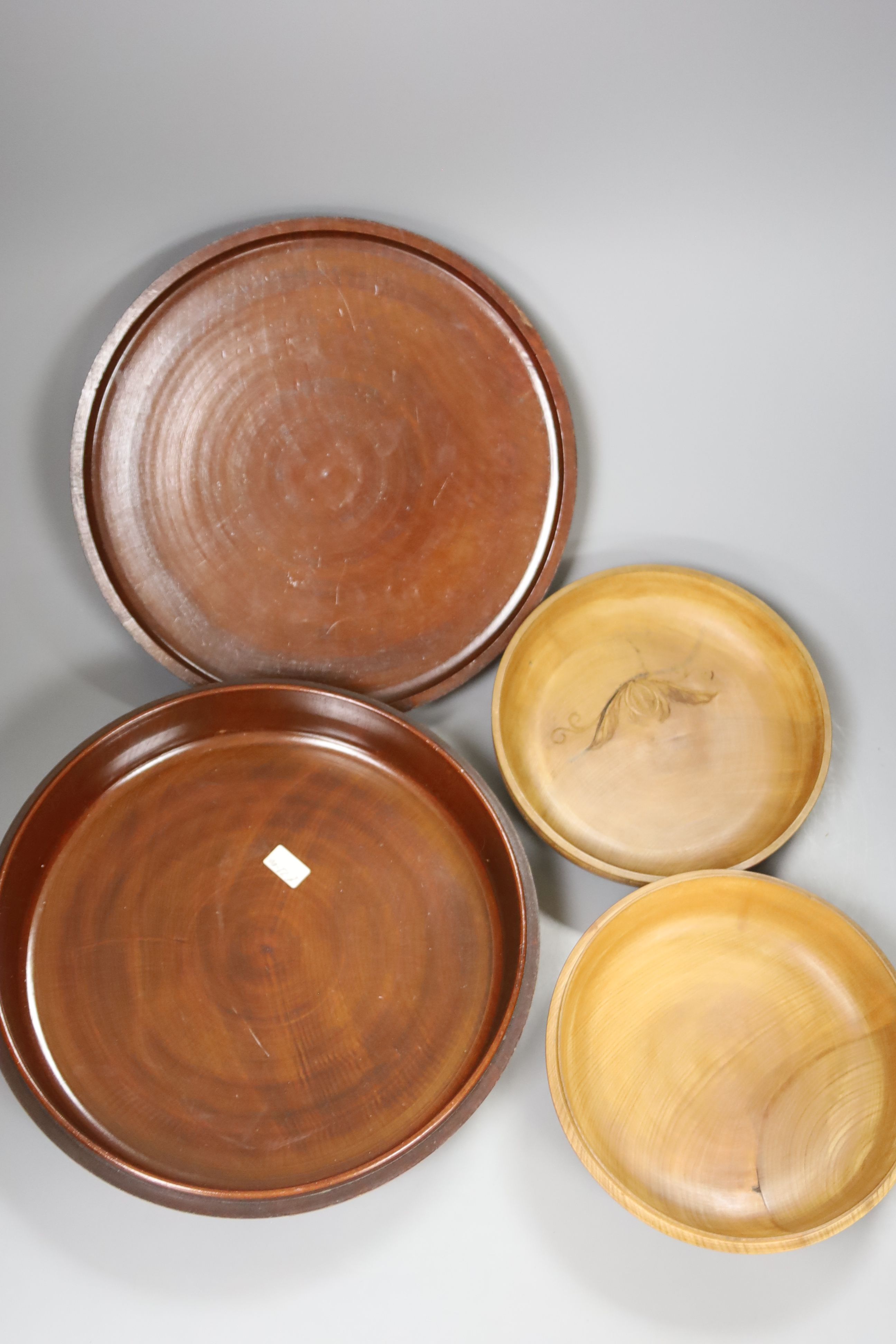 Two Japanese shallow carved wood circular lidded boxes, largest 27cm diameter